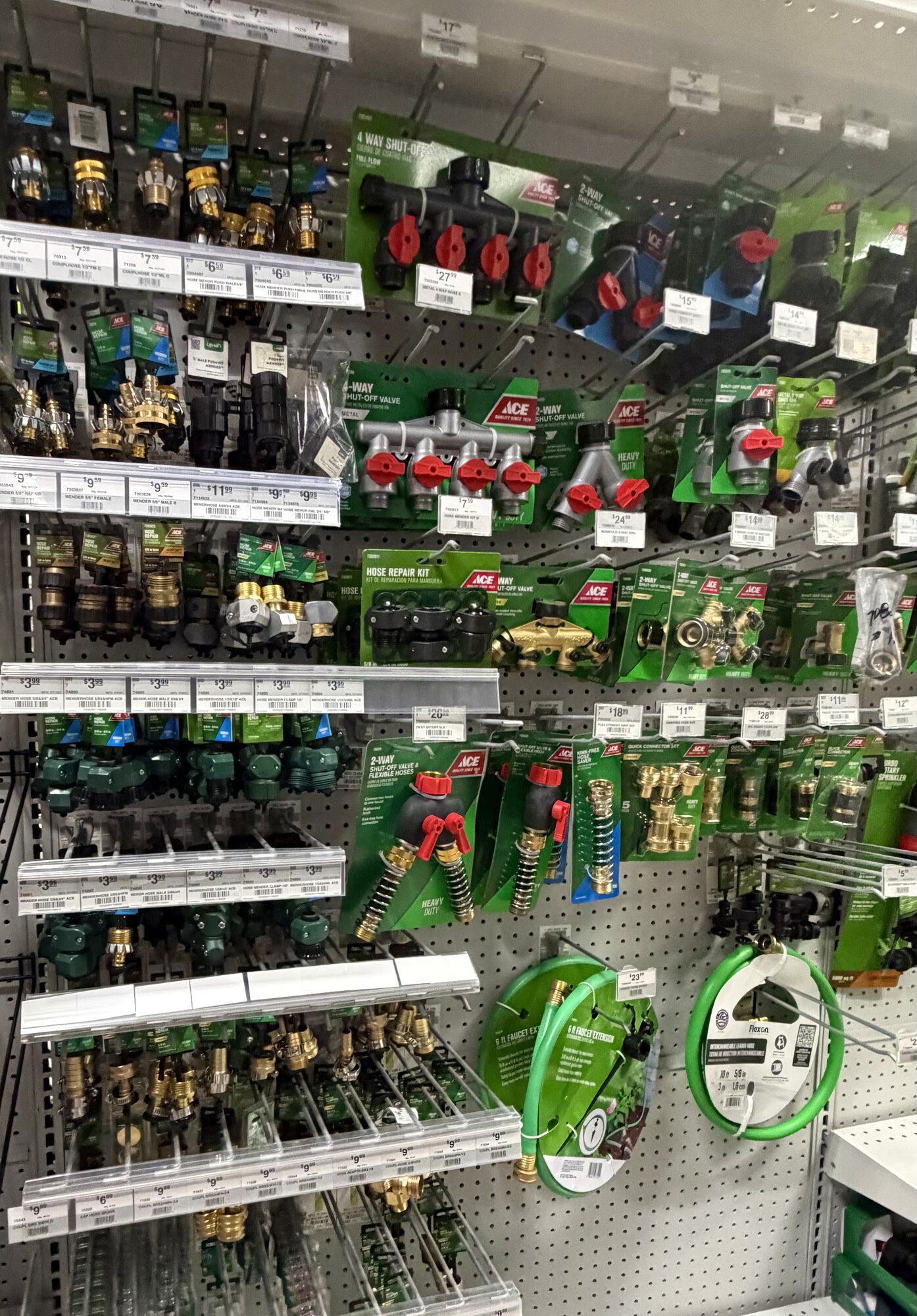 A display of Ace brand garden hose connectors, 4-way shut-off valves, and hose repair kits at Hessler Paint & Hardware in Delray Beach, Florida.