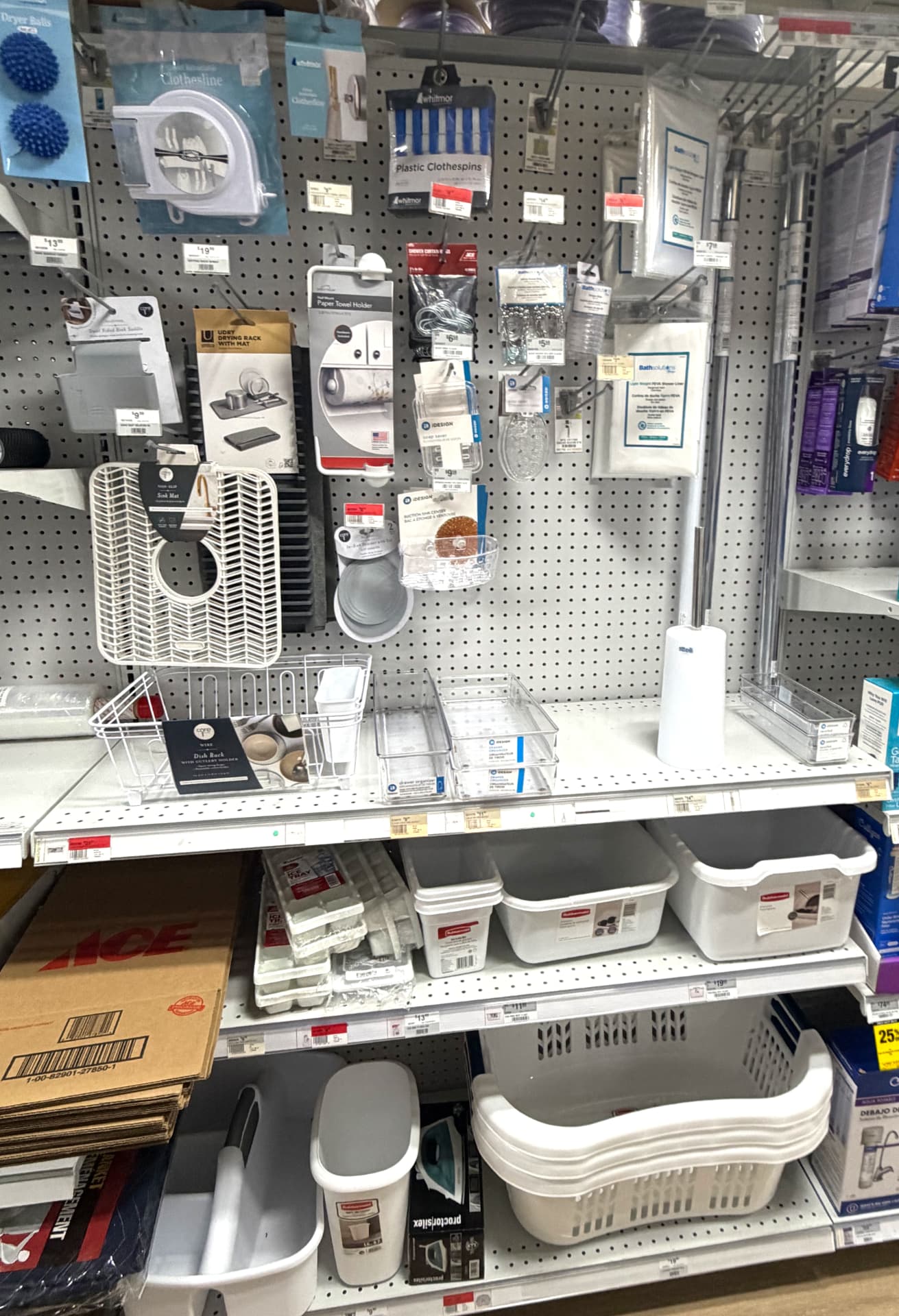 Laundry and home organization display with drying racks, clothespins, bins, baskets and shower curtain liners