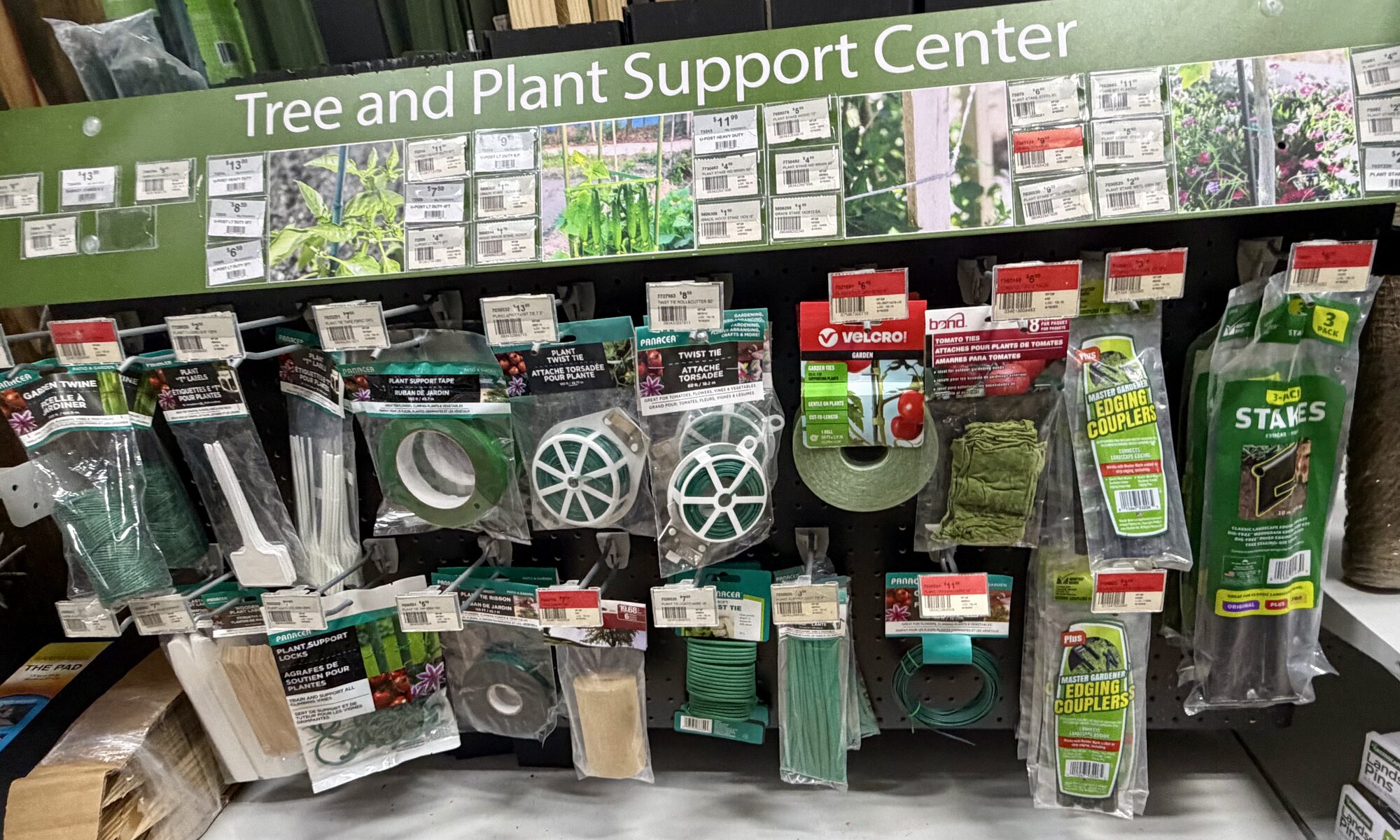 A retail display of gardening supplies including Velcro Brand plant ties, Bond tomato ties, and plant stakes at Hessler Paint & Hardware in Delray Beach, Florida.
