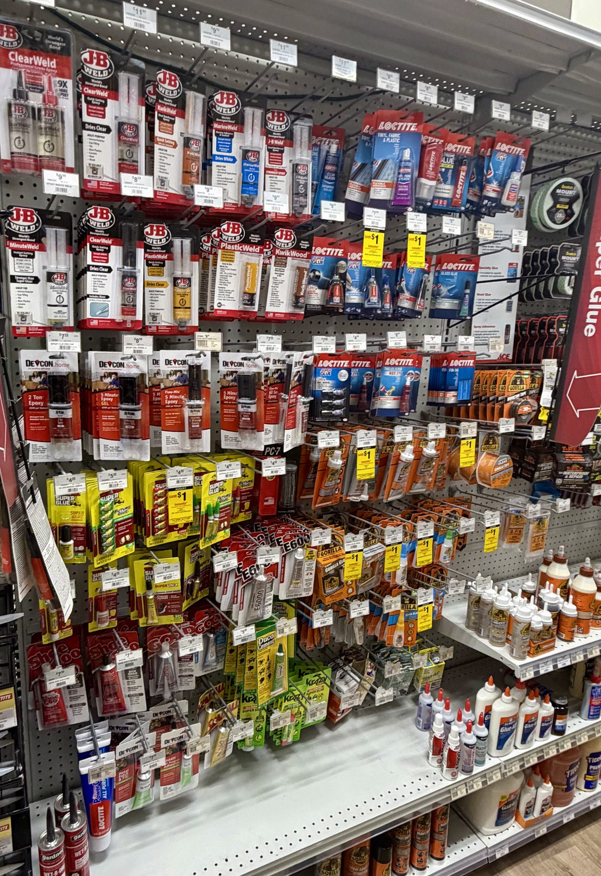 Pegboard display of epoxies and adhesives featuring J-B Weld, Loctite, Devcon, Gorilla Glue, and Krazy Glue products at Hessler Paint & Hardware in Delray Beach, Florida.