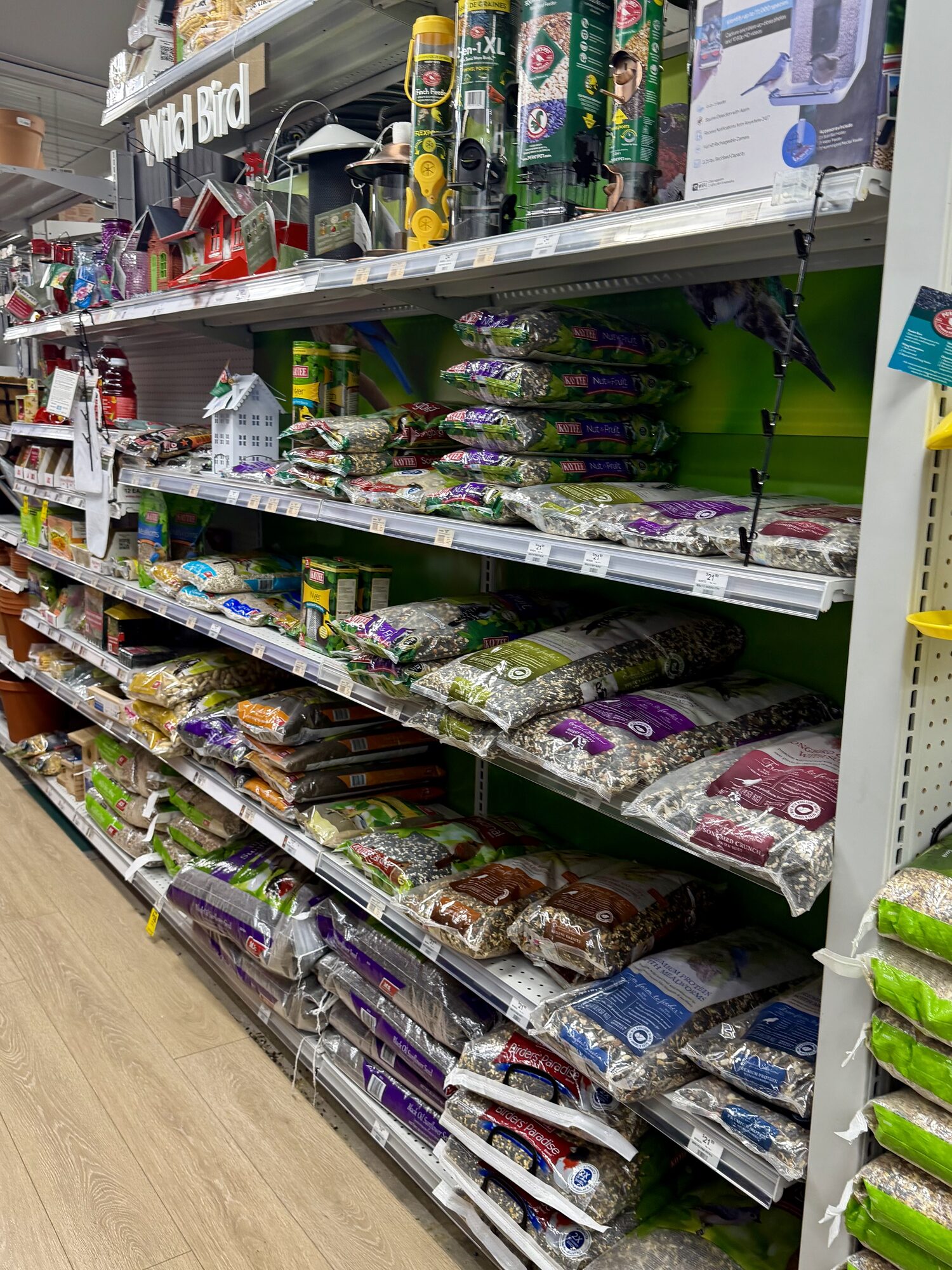 A wide variety of wild bird seed bags, bird feeders, and birdhouses on display at Hessler Paint & Hardware in Delray Beach, Florida.