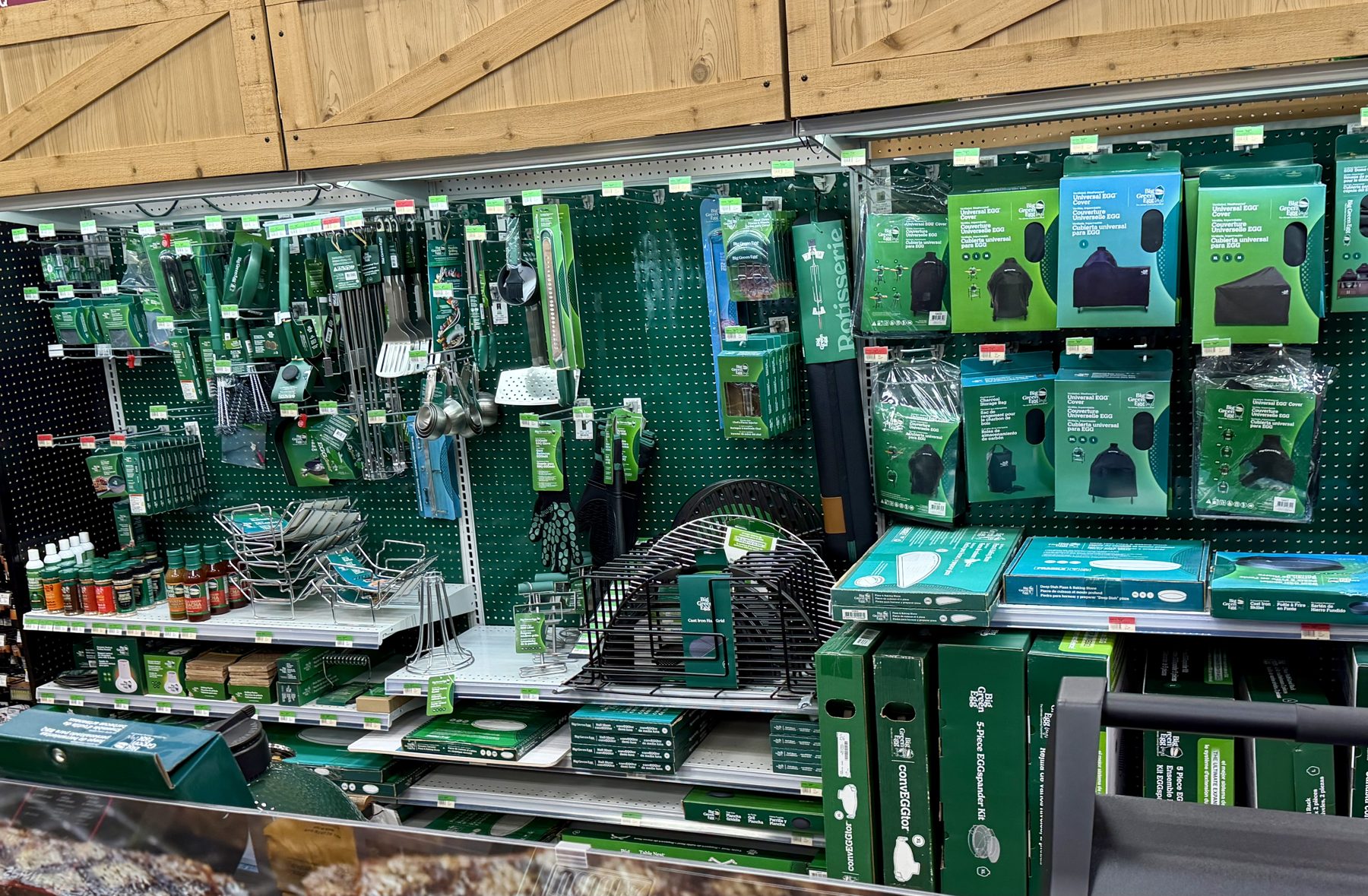 Display of Big Green Egg grill accessories, covers, utensils, racks, and seasonings at Hessler Paint & Hardware in Delray Beach, Florida.
