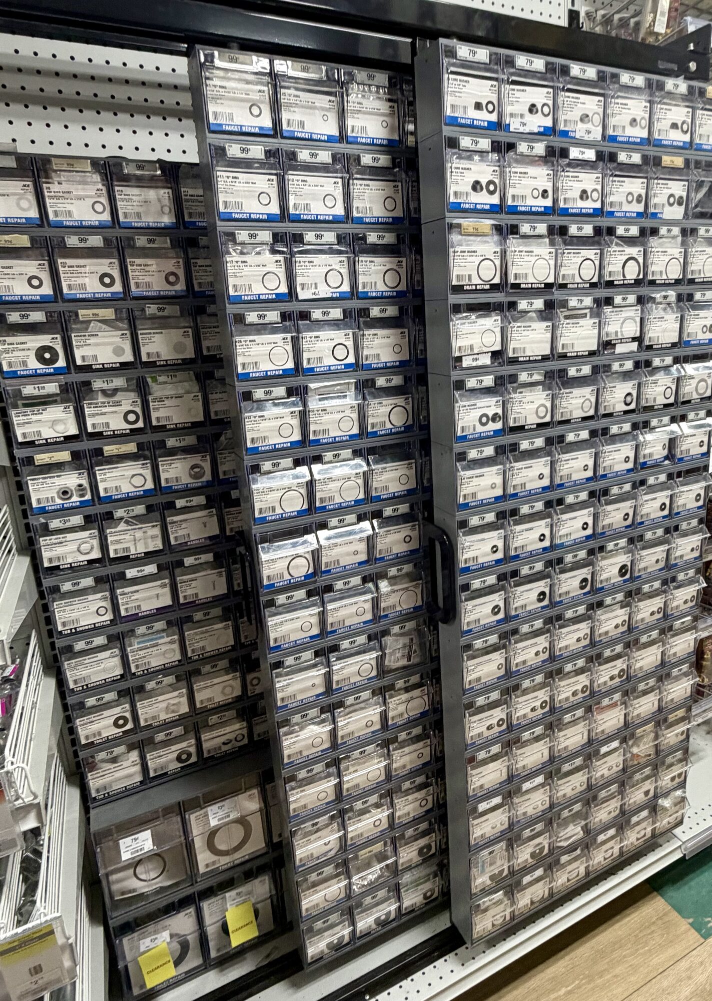 A large organizational display of faucet repair parts, O-rings, and gaskets at Hessler Paint & Hardware in Delray Beach, Florida.