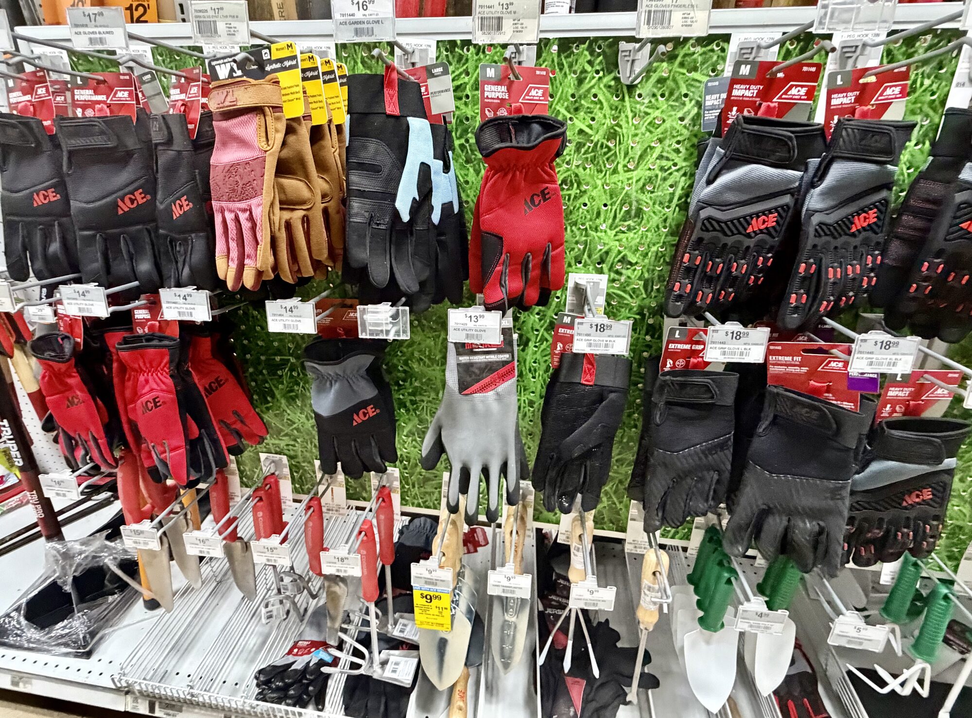 A display of Ace brand work gloves and small hand garden tools including trowels and cultivators at Hessler Paint & Hardware in Delray Beach, Florida.