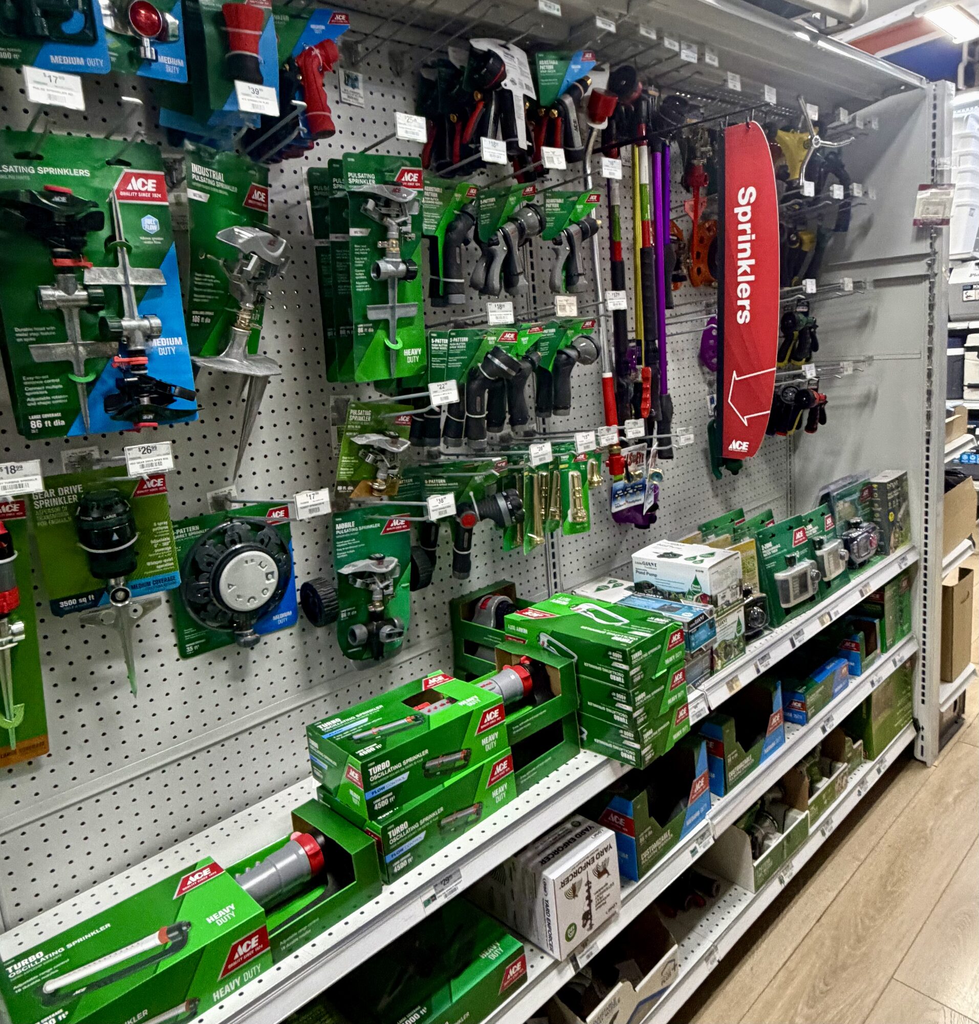 A wide variety of Ace brand pulsating sprinklers, oscillating sprinklers, and hose nozzles at Hessler Paint & Hardware in Delray Beach, Florida.