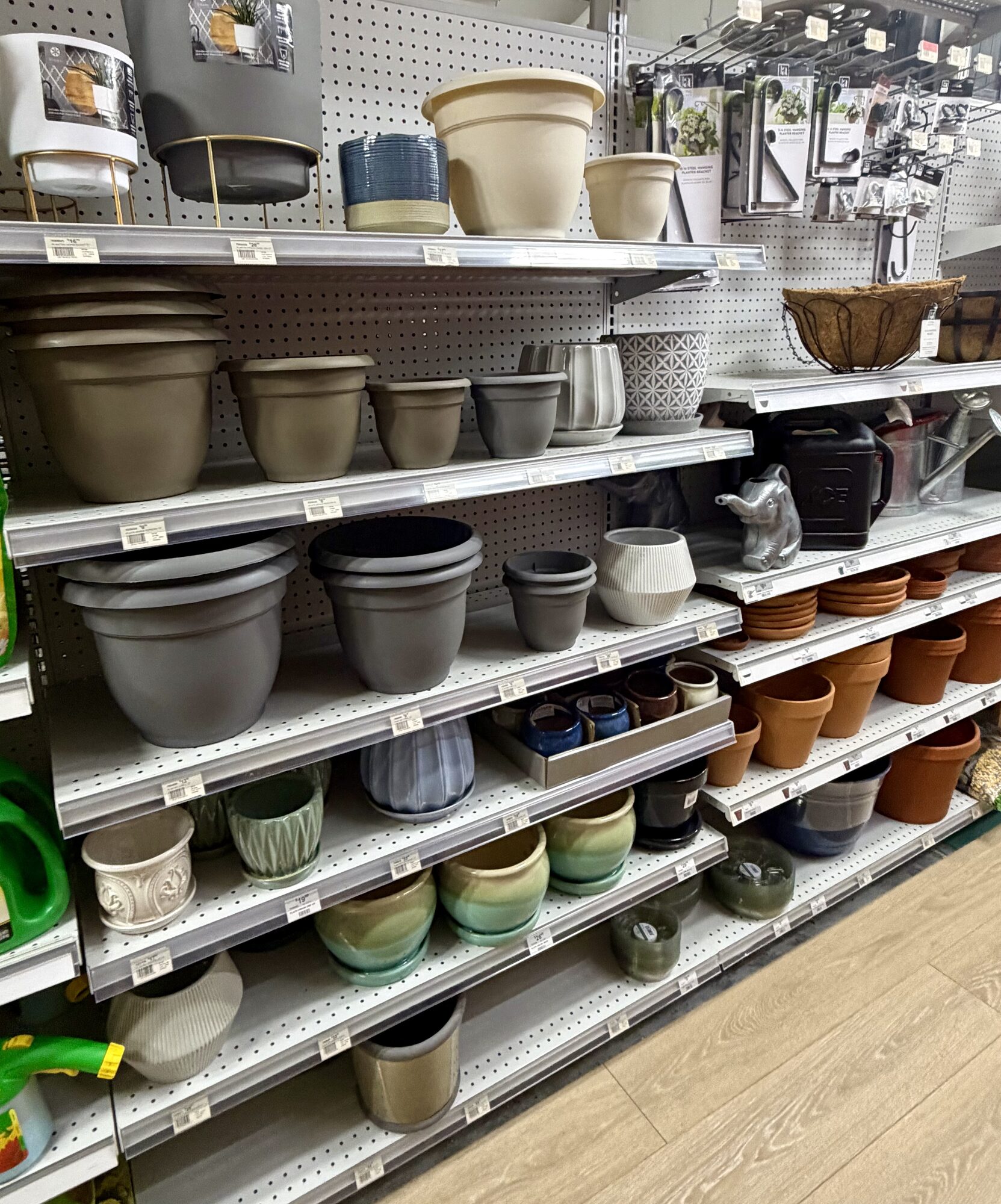 A variety of ceramic and plastic garden pots, planters, and saucers in various sizes and colors at Hessler Paint & Hardware in Delray Beach, Florida.
