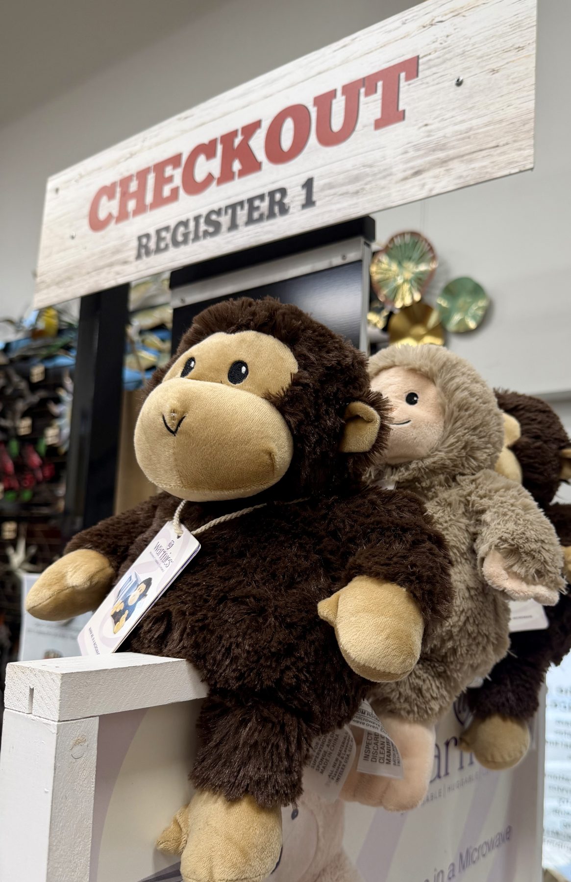 Plush Warmies microwavable stuffed monkey and animal plushies on display at Checkout Register 1 at Hessler Paint & Hardware in Delray Beach, Florida.