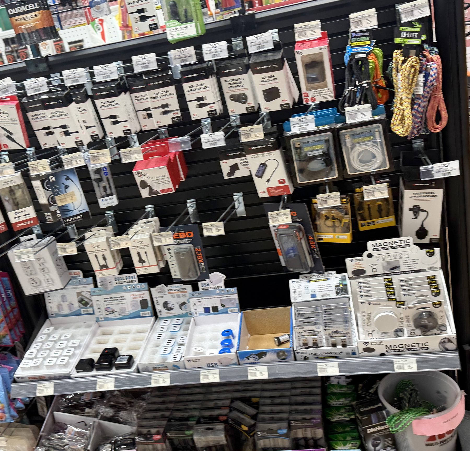 Display shelf of electrical charging accessories, USB-C cables, wall blocks, magnetic wireless chargers, and car adapters at Hessler Paint & Hardware in Delray Beach, Florida.