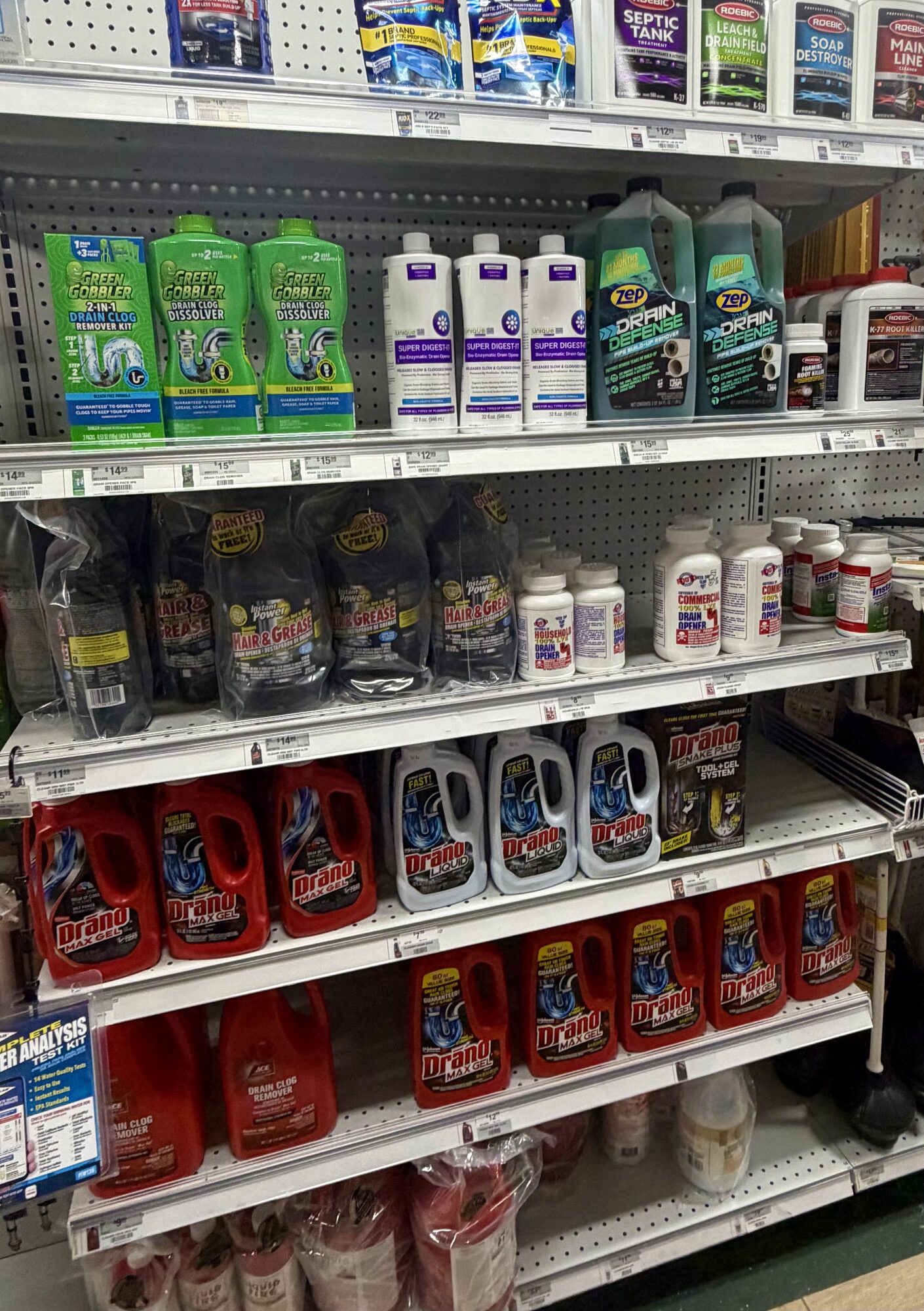 Shelves of Drano, Green Gobbler, Zep, and Roebic drain cleaners and septic treatments at Hessler Paint & Hardware in Delray Beach, Florida.