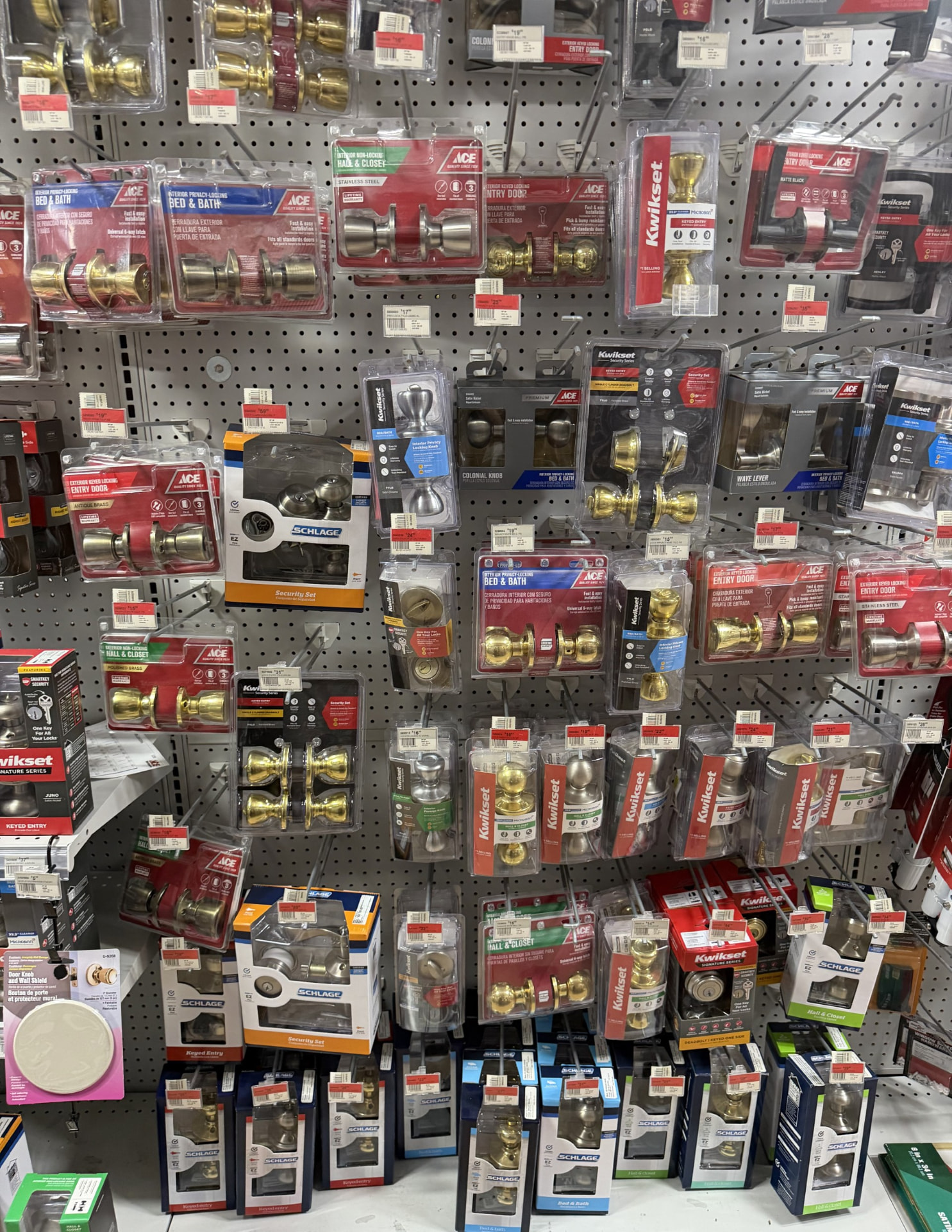 Wall of Kwikset, Schlage and Ace door knobs, levers and entry locksets