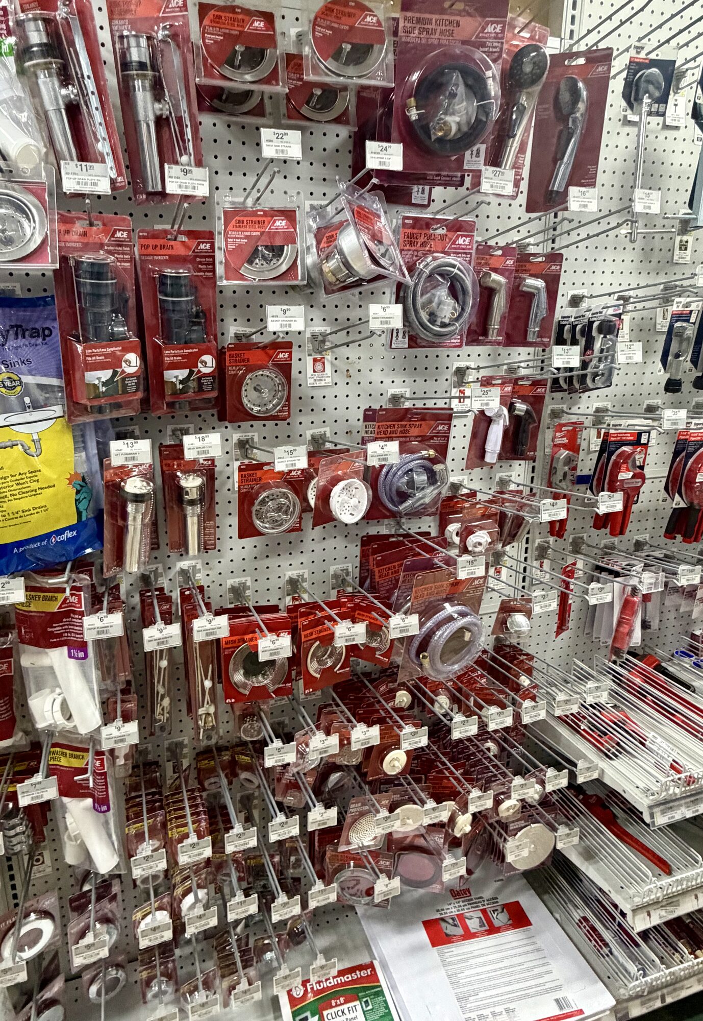 Ace Hardware brand kitchen spray hoses, sink strainers, P-traps, and Fluidmaster plumbing repair parts at Hessler Paint & Hardware in Delray Beach, Florida.