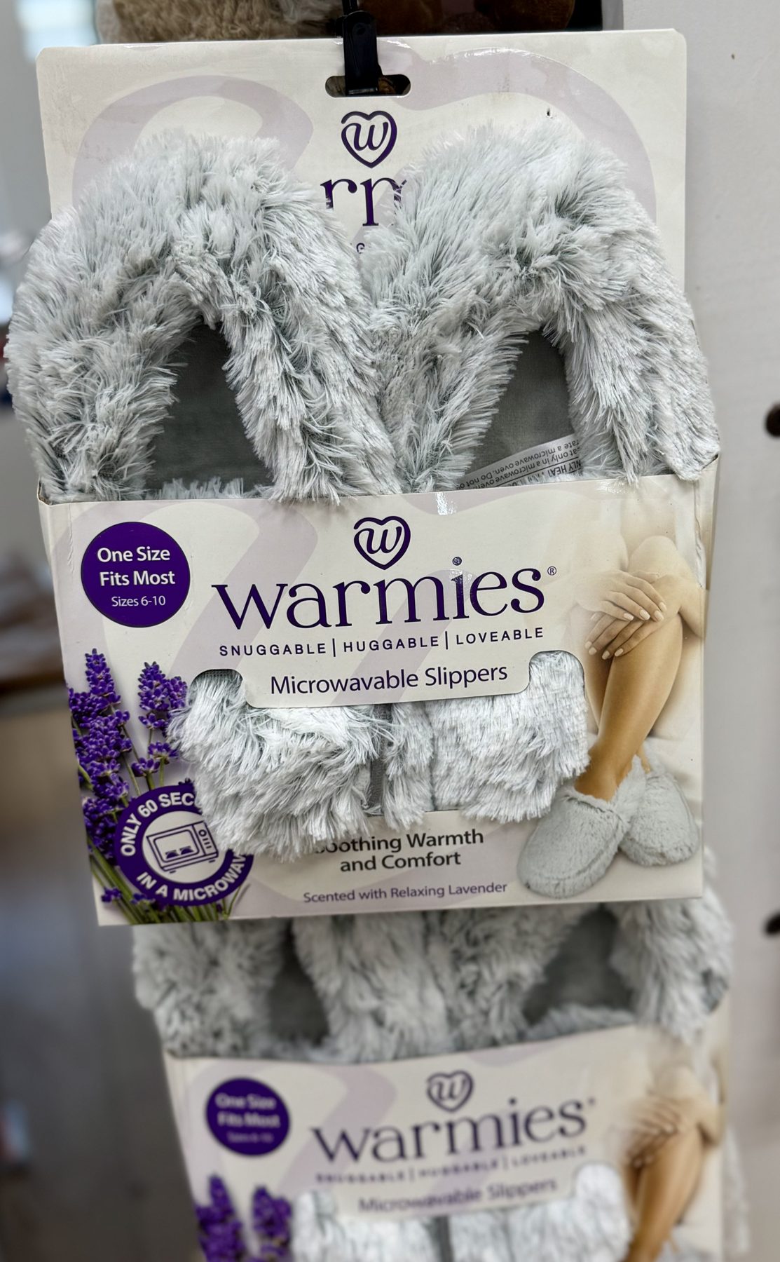 Grey Warmies microwavable plush slippers scented with relaxing lavender on display at Hessler Paint & Hardware in Delray Beach, Florida.