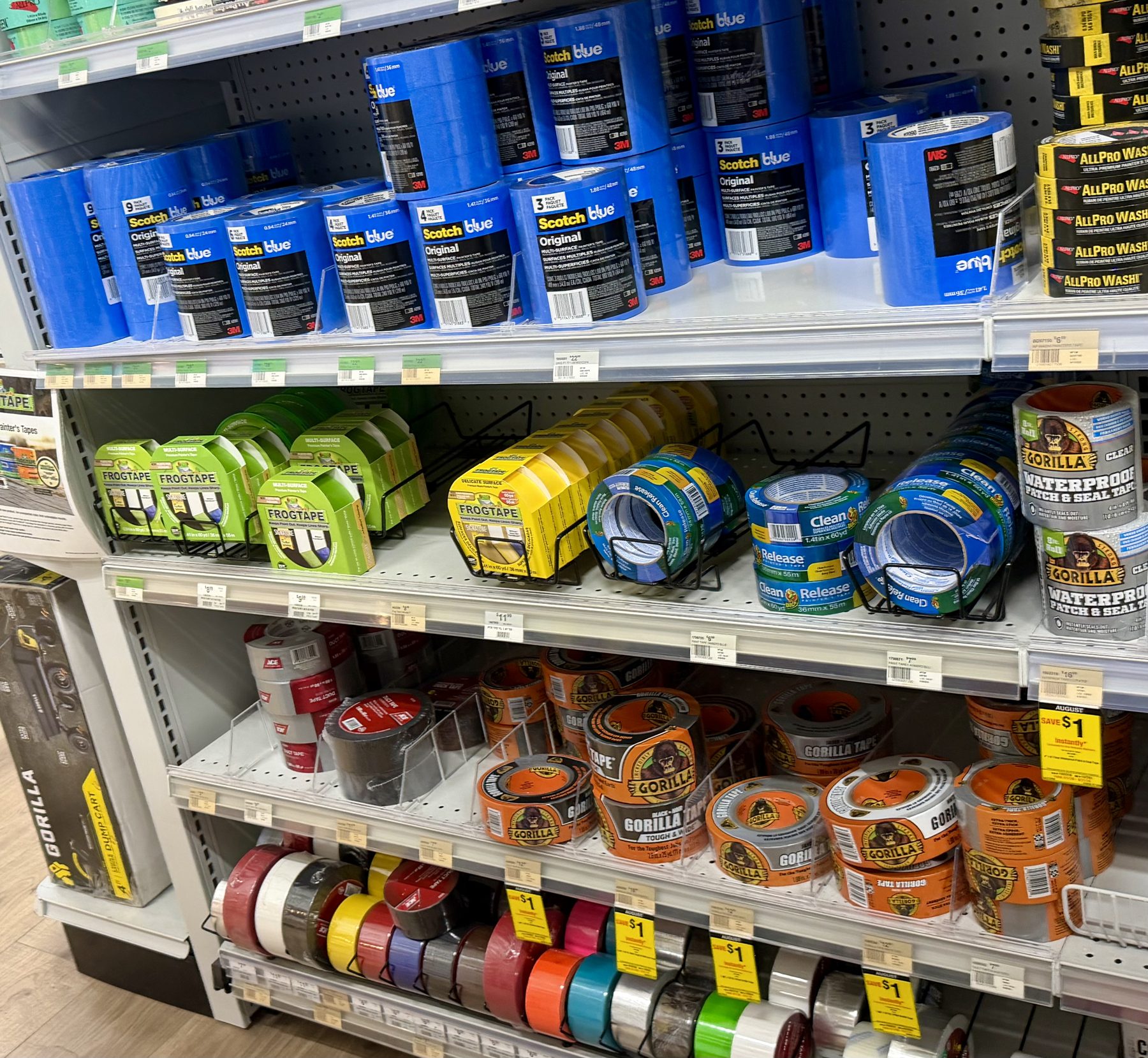 Store shelf stocked with 3M ScotchBlue painter's tape, FrogTape, Clean Release painter's tape, and Gorilla Tape heavy-duty adhesive rolls at Hessler Paint & Hardware in Delray Beach, Florida.