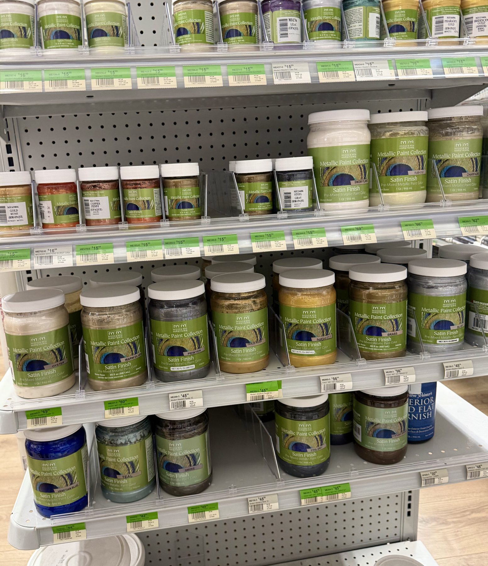 Shelves stocked with Modern Masters Metallic Paint Collection jars in various shades and sizes at Hessler Paint & Hardware in Delray Beach, Florida.