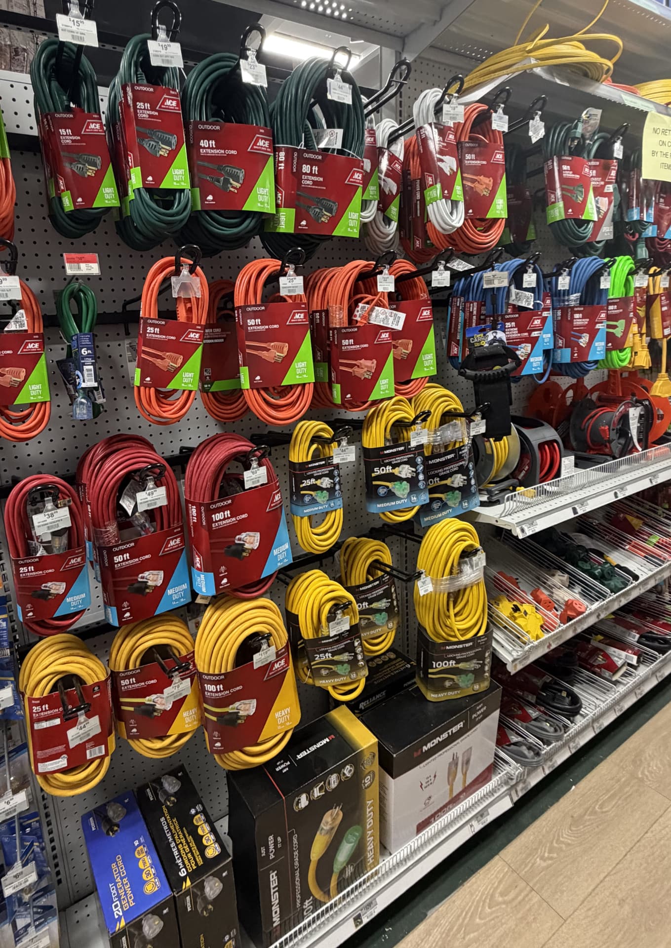 Extension cords in light, medium and heavy duty hanging on pegboard