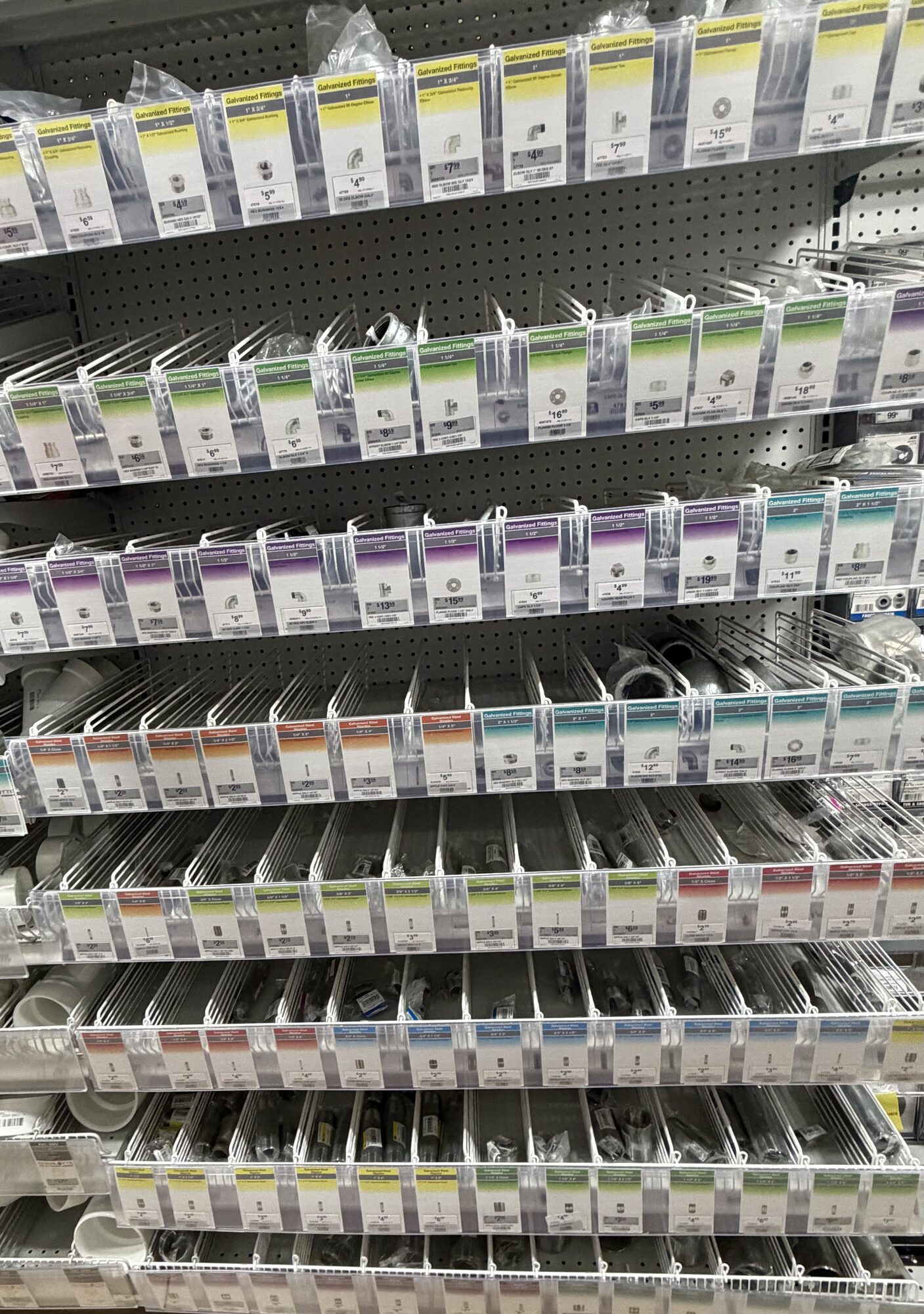 A wide selection of galvanized and PVC plumbing fittings organized in bins at Hessler Paint & Hardware in Delray Beach, Florida.