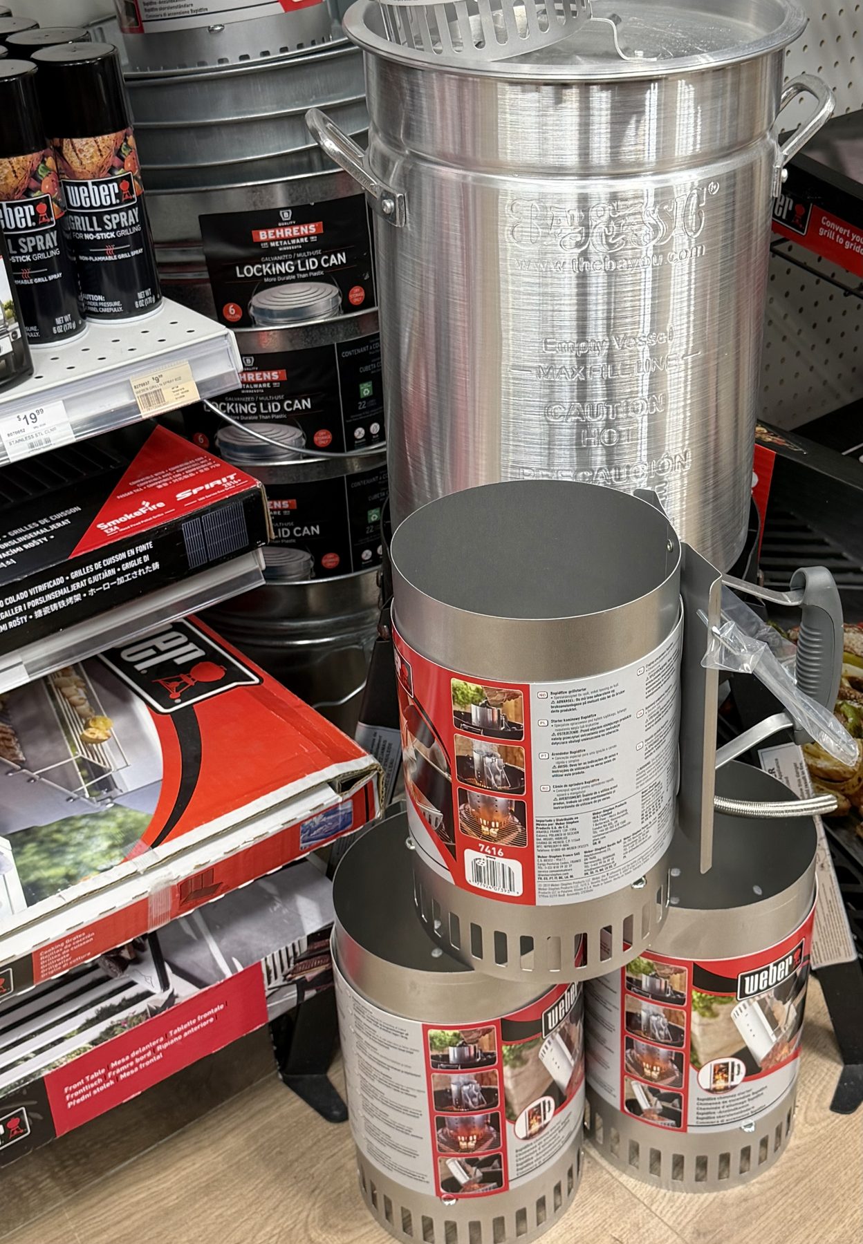 Weber charcoal chimney starters, Weber grill spray, and a Bayou Classic aluminum stock pot on display at Hessler Paint & Hardware in Delray Beach, Florida.
