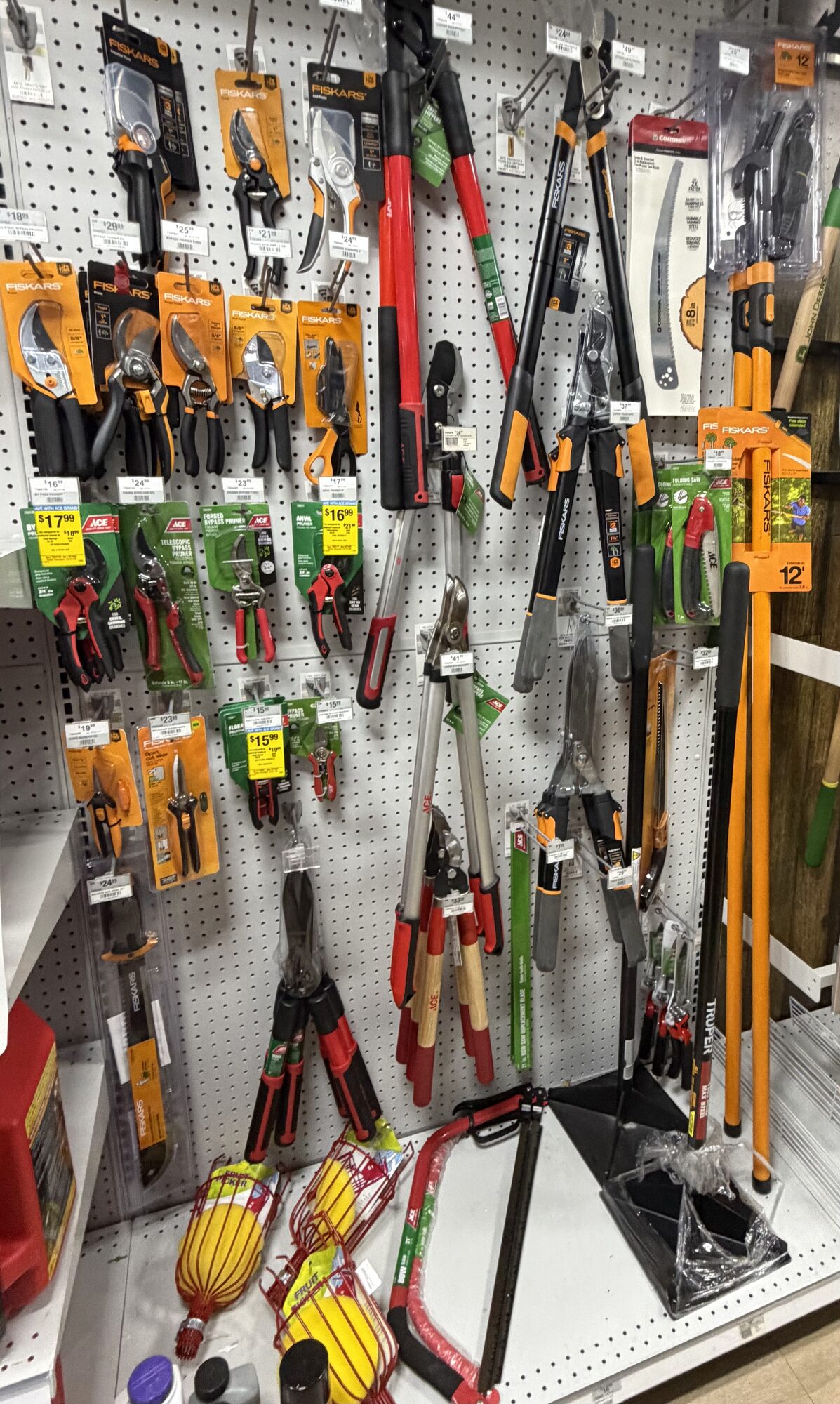 Display of Fiskars garden shears, loppers, hand pruners, and Truper pole saws at Hessler Paint & Hardware in Delray Beach, Florida.