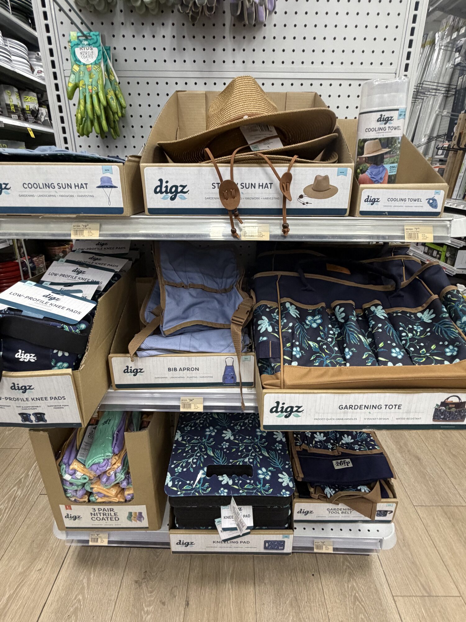 Digz brand gardening apparel including sun hats, knee pads, bib aprons, and floral gardening totes at Hessler Paint & Hardware in Delray Beach, Florida.