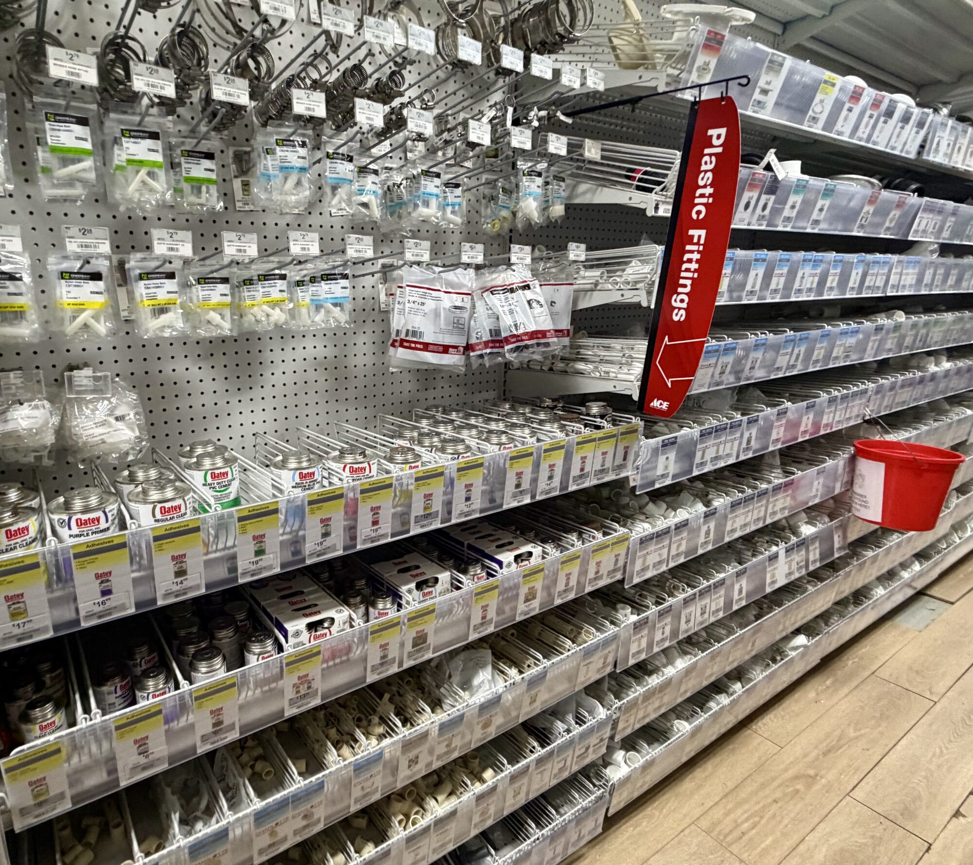 Shelves of plastic fittings, PVC pipes, and Oatey solvent cements and primers at Hessler Paint & Hardware in Delray Beach, Florida.