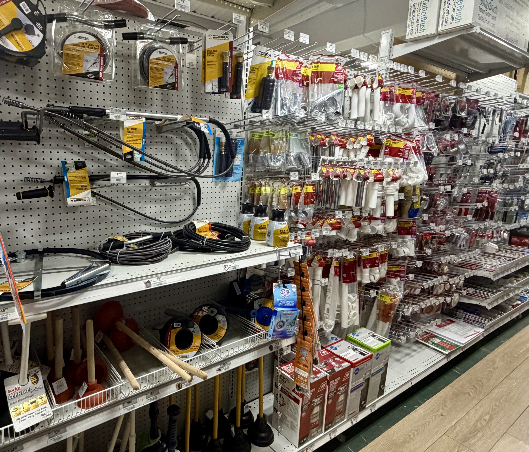 Cobra plumbing tools, augers, plungers, and GutterBrush products on display at Hessler Paint & Hardware in Delray Beach, Florida.