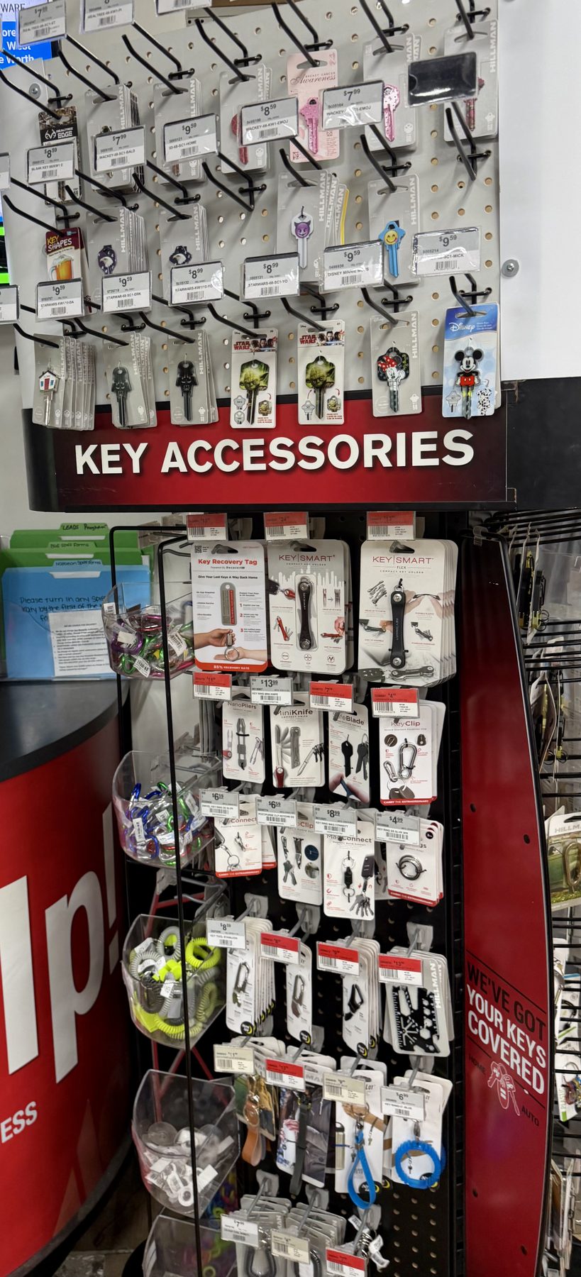 Display of decorative novelty key blanks by Hillman, KeySmart key organizers, and various key rings at Hessler Paint & Hardware in Delray Beach, Florida.