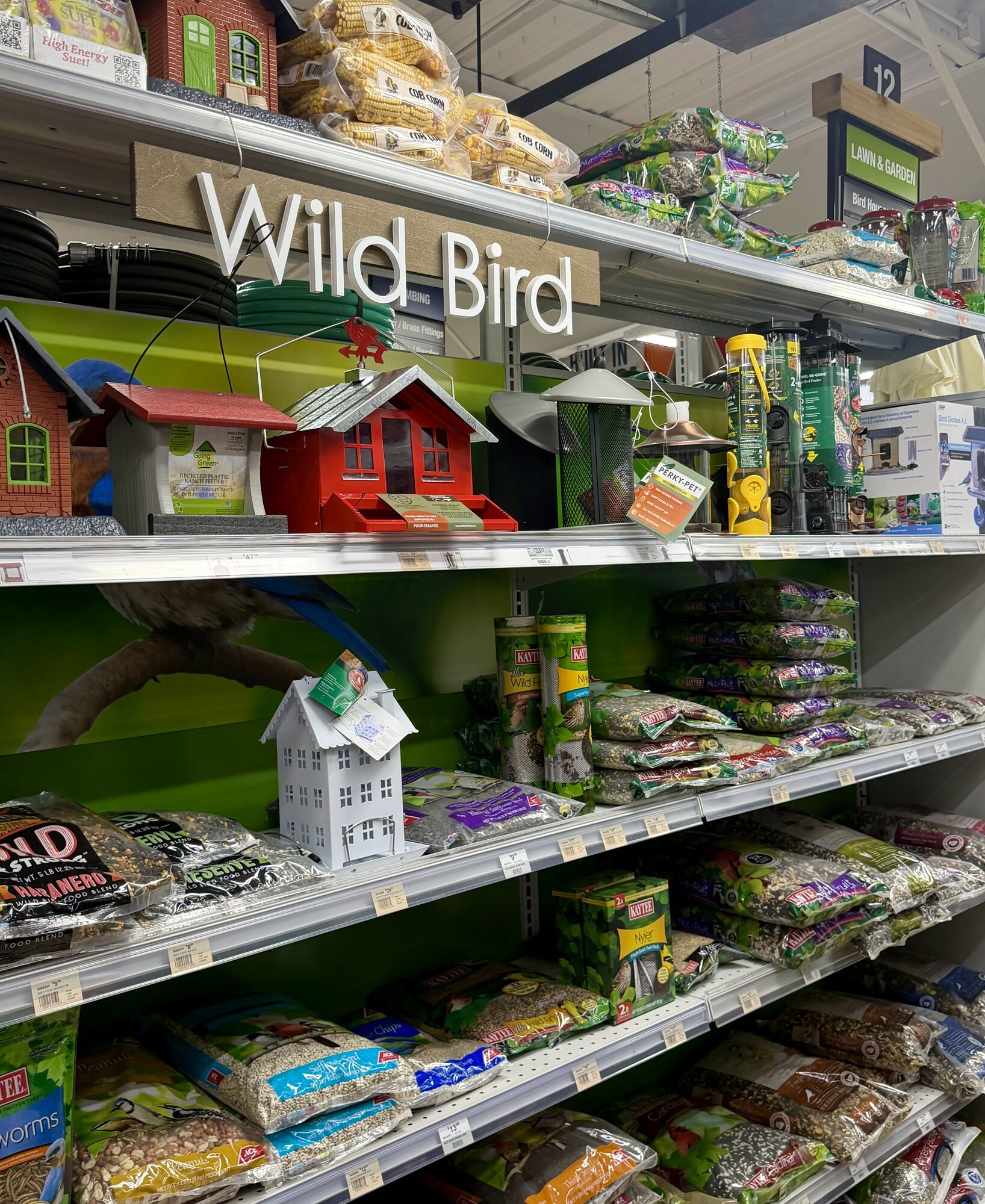 A selection of wild bird supplies including Kaytee bird seed, Perky-Pet bird feeders, and cob corn at Hessler Paint & Hardware in Delray Beach, Florida.