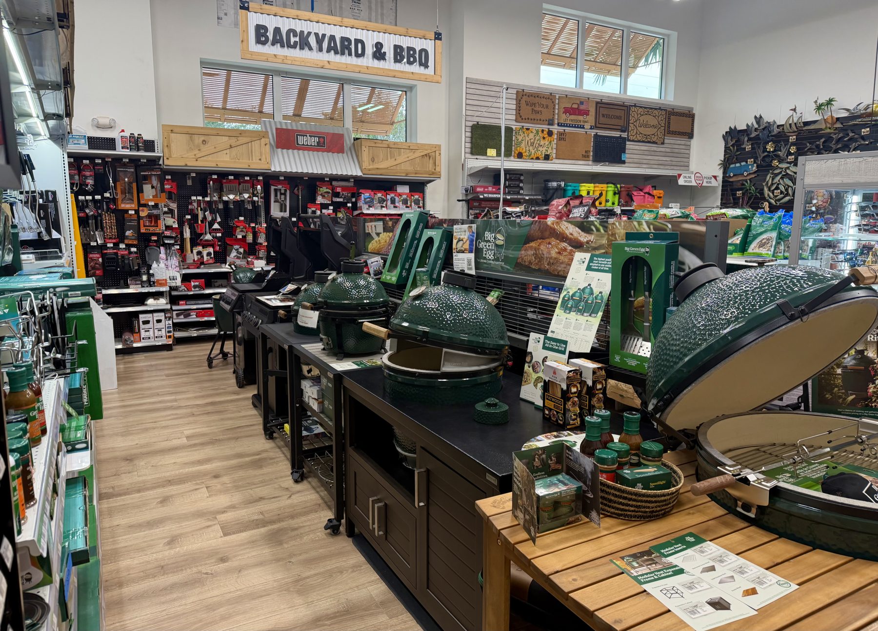 Big Green Egg ceramic kamado grills, Weber gas grills, barbecue accessories, and outdoor doormats in the Backyard & BBQ department at Hessler Paint & Hardware in Delray Beach, Florida.