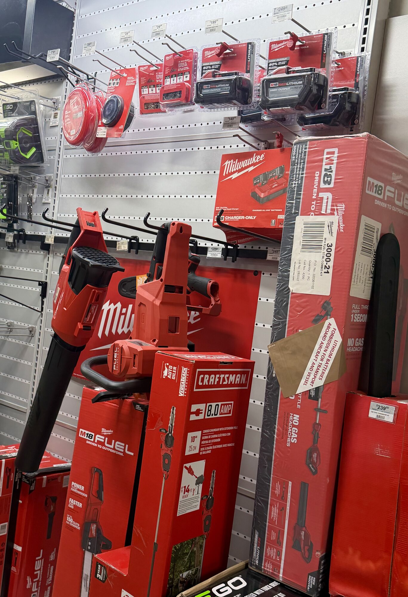 Milwaukee M18 FUEL power tools, batteries, and Craftsman pole saw equipment on display at Hessler Paint & Hardware in Delray Beach, Florida.