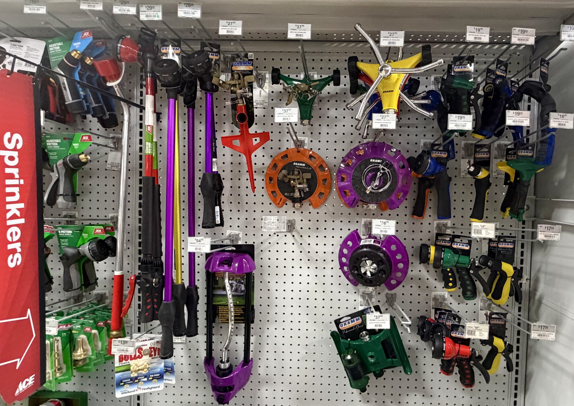 A display of Dramm and Ace Hardware sprinklers, spray nozzles, and watering wands at Hessler Paint & Hardware in Delray Beach, Florida.