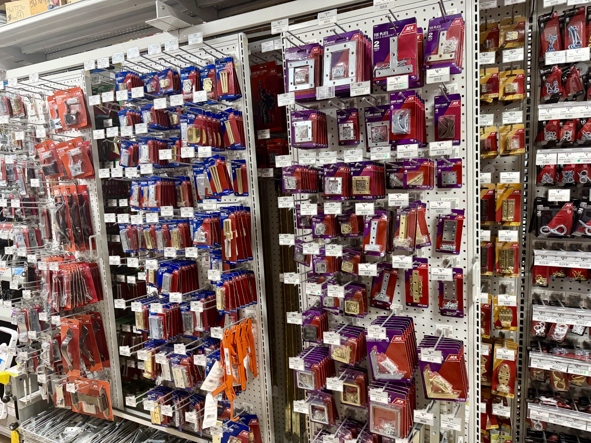 Aisle of corner braces, mending plates, hinges and cabinet hardware in packaged sets