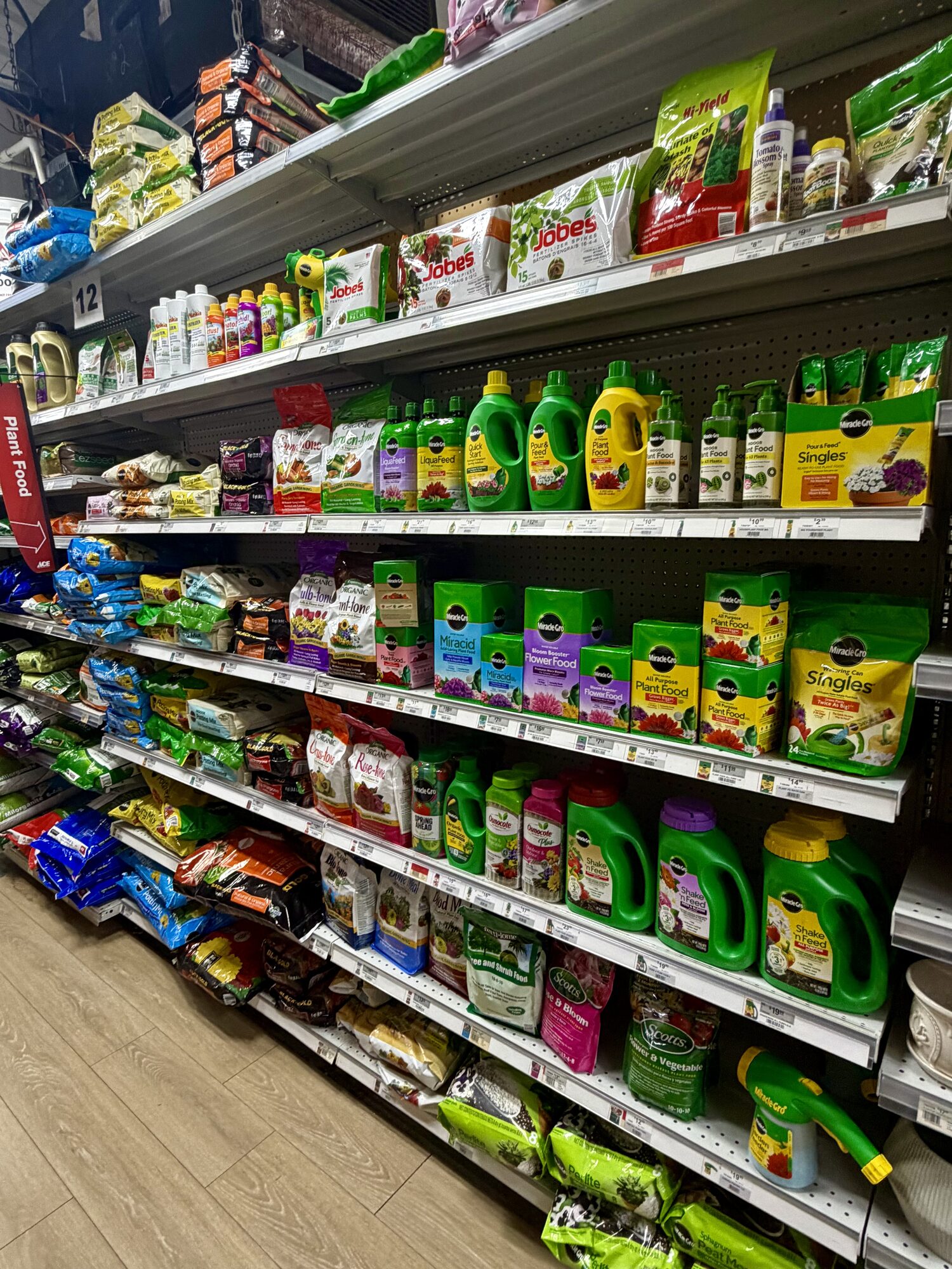 Shelves of Miracle-Gro, Scotts, and Jobe's plant food and garden fertilizers at Hessler Paint & Hardware in Delray Beach, Florida.