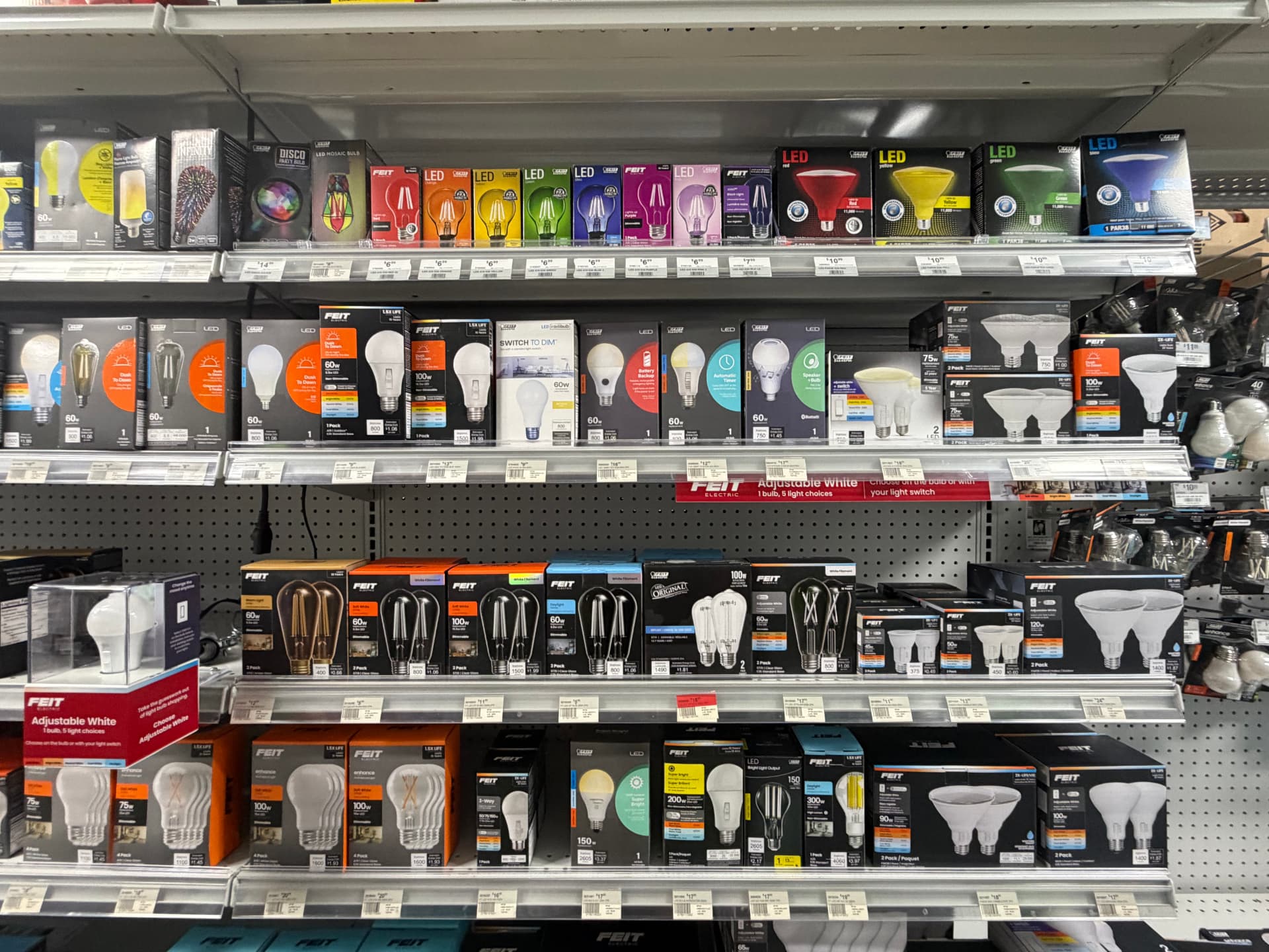 Shelves of specialty LED bulbs including colored, dusk-to-dawn and adjustable white